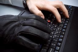 Computer theft with hands on laptop keyboard