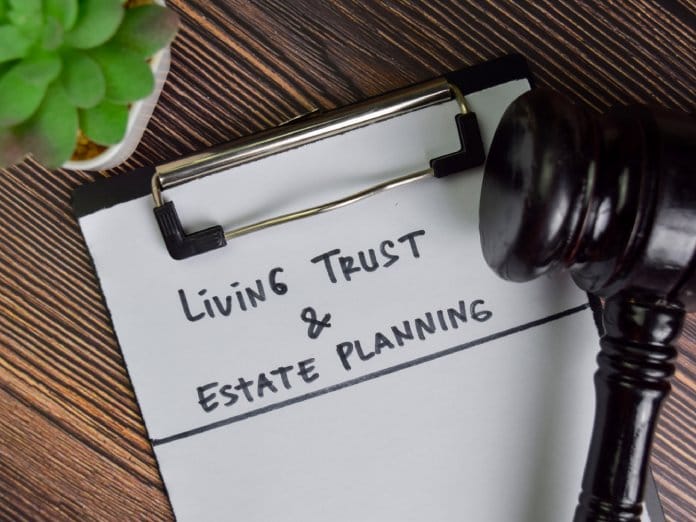 A clipboard with a living will and estate planning document.