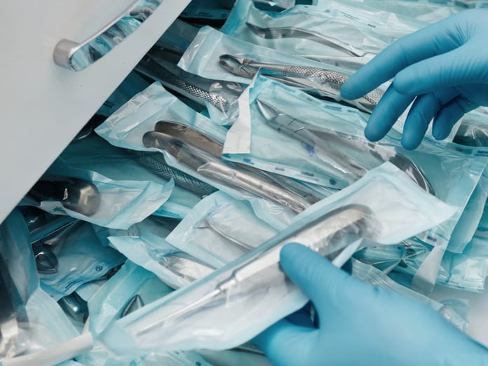 A surgical room drawer pulled out and full of disposable surgical instruments. Each one is wrapped in packaging.